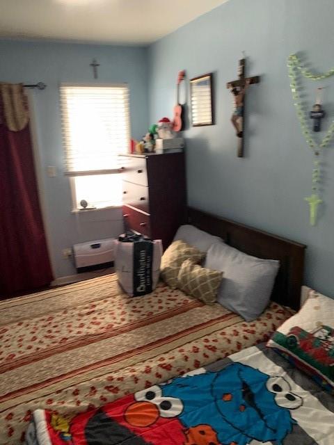 1129 Broadway Brooklyn, NY 11221 - Photo 9 of 15 a bedroom with a bed and wooden floor