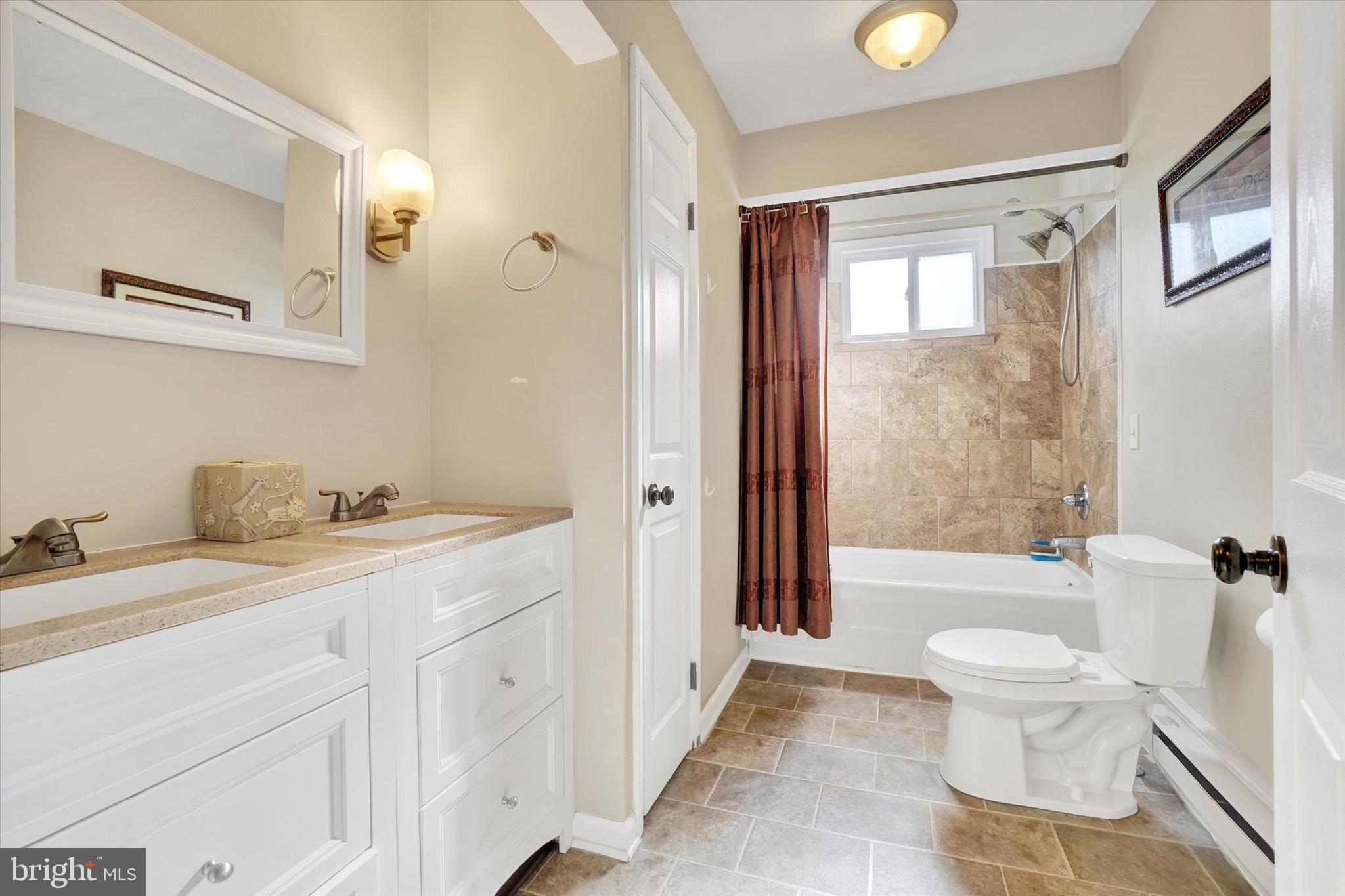 1270 Glendale Road York, PA 17403 - Photo 15 of 31 a bathroom with a granite countertop sink a toilet a mirror and a tub