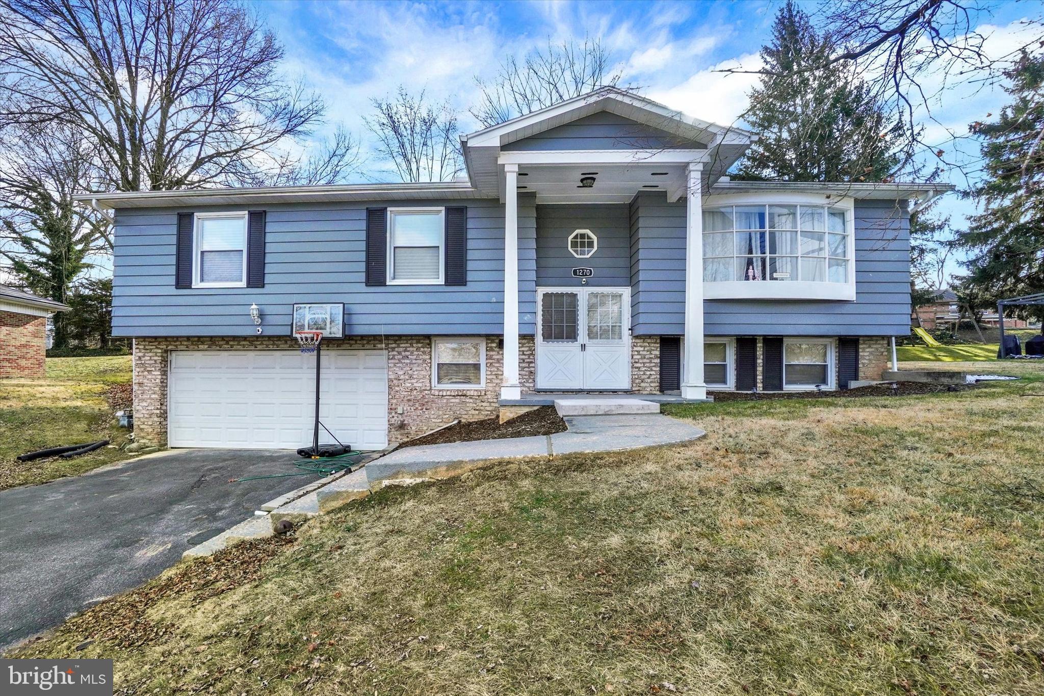 1270 Glendale Road York, PA 17403 - Photo 2 of 31 a front view of a house with a yard and garage
