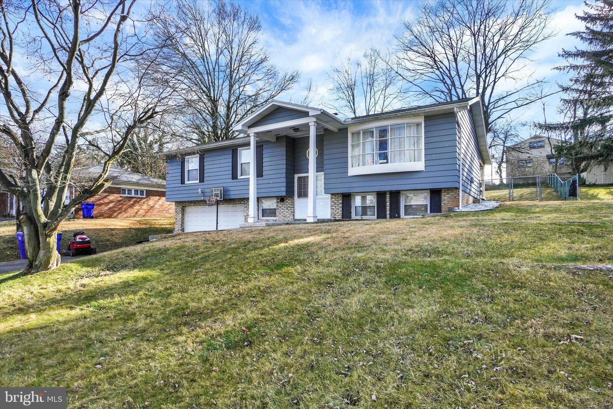 1270 Glendale Road York, PA 17403 - Photo 27 of 31 a view of a yard in front of a brick house with large windows