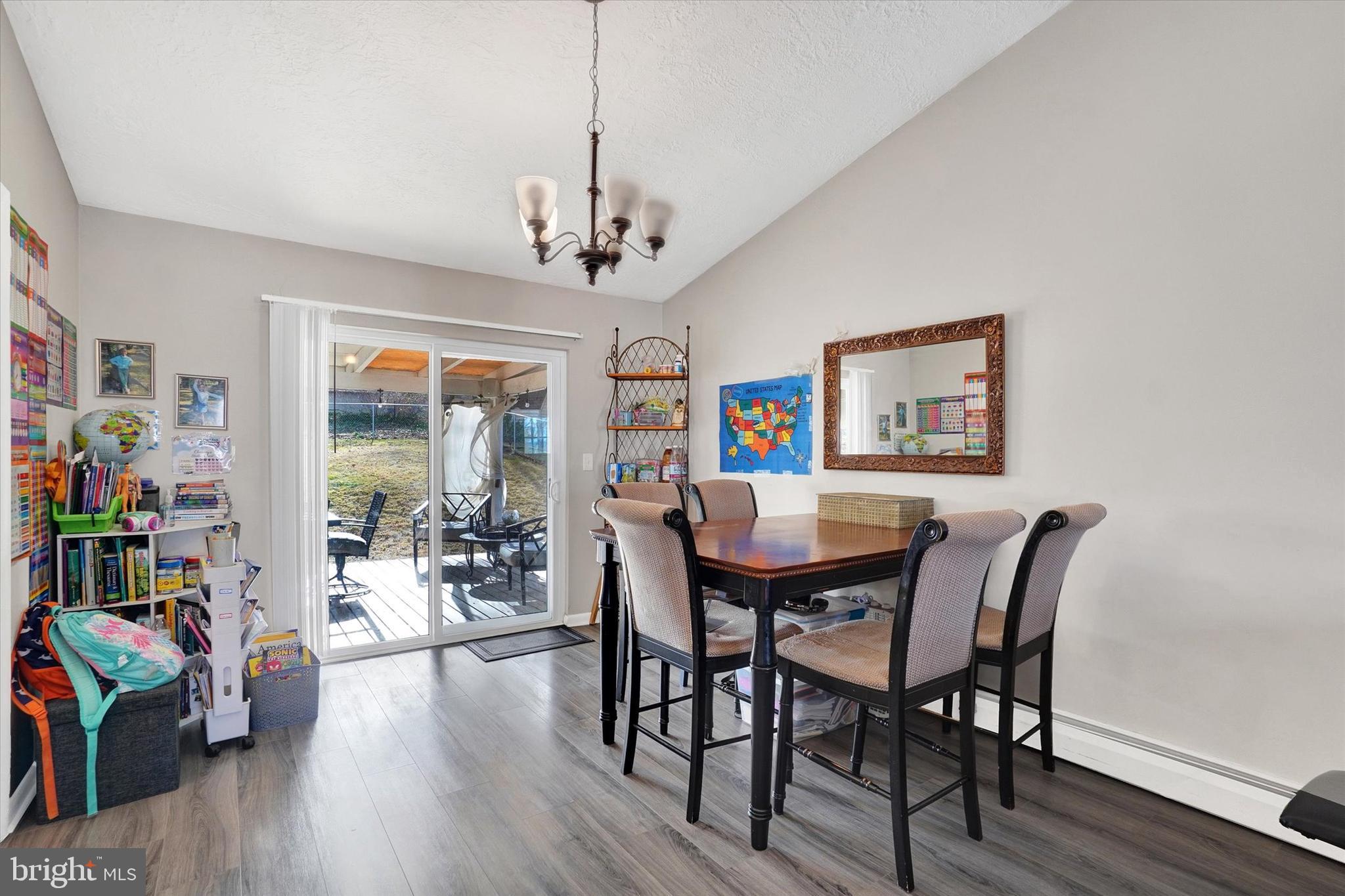 1270 Glendale Road York, PA 17403 - Photo 6 of 31 a view of a dining room with furniture wooden floor and a chandelier