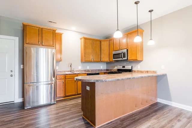 a view of a livingroom with a furniture wooden floor and window