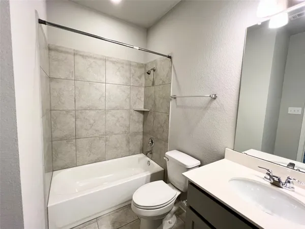 an empty room with closet and windows