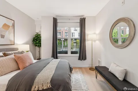 a bedroom with a bed and a potted plant