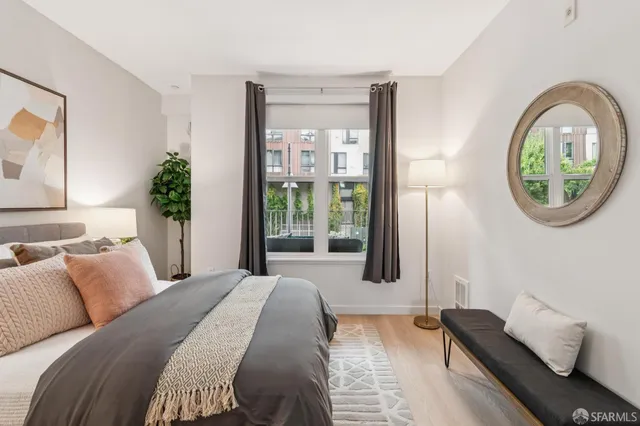 a bedroom with a bed and a potted plant