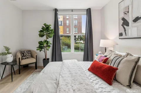 a bedroom with a bed and a night stand