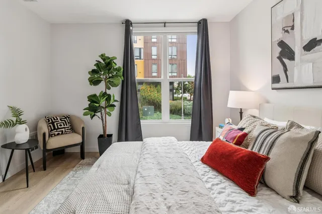 a bedroom with a bed and a night stand