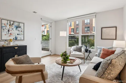 a kitchen with stainless steel appliances granite countertop a refrigerator a stove top oven and a sink with wooden floor