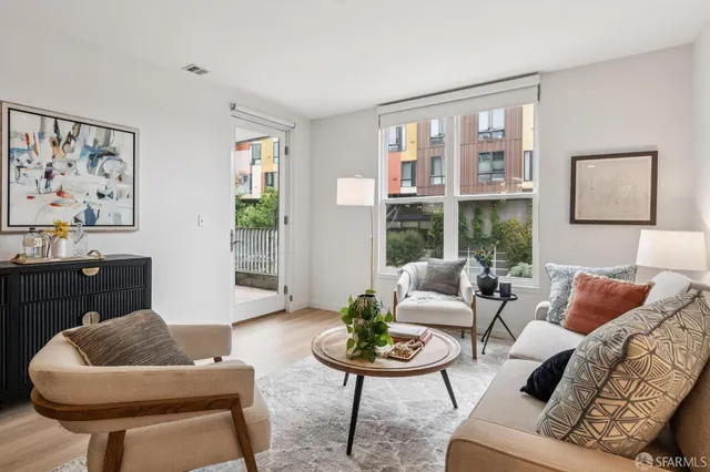 a kitchen with stainless steel appliances granite countertop a refrigerator a stove top oven and a sink with wooden floor