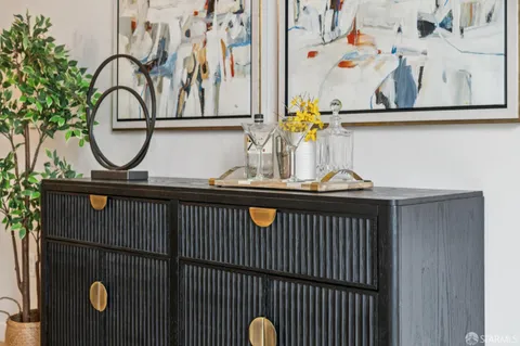 a kitchen with stainless steel appliances granite countertop a stove a sink dishwasher a microwave oven with white cabinets and wooden floor