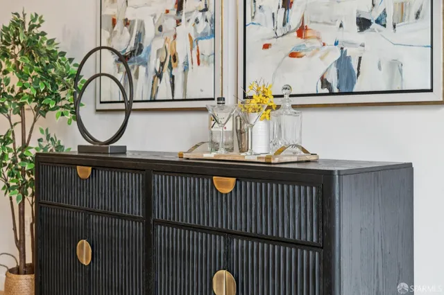 a kitchen with stainless steel appliances granite countertop a stove a sink dishwasher a microwave oven with white cabinets and wooden floor