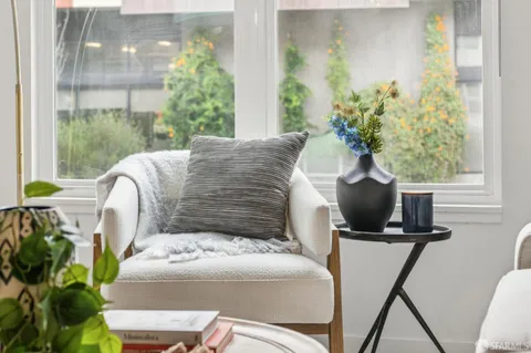 a living room with furniture and a potted plant
