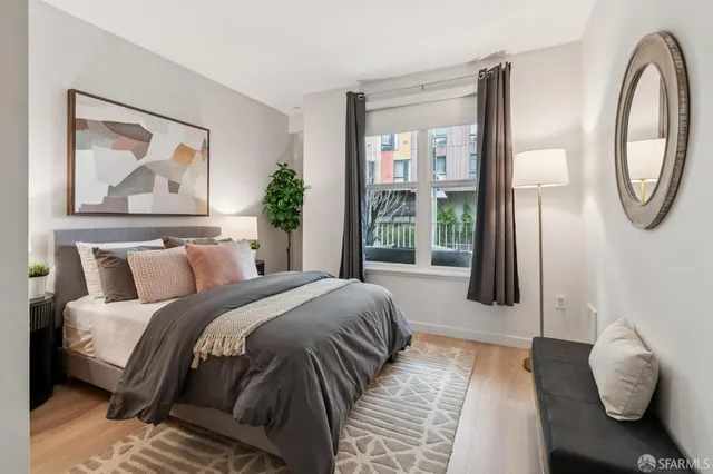 a bathroom with a granite countertop bathtub shower sink vanity mirror and toilet