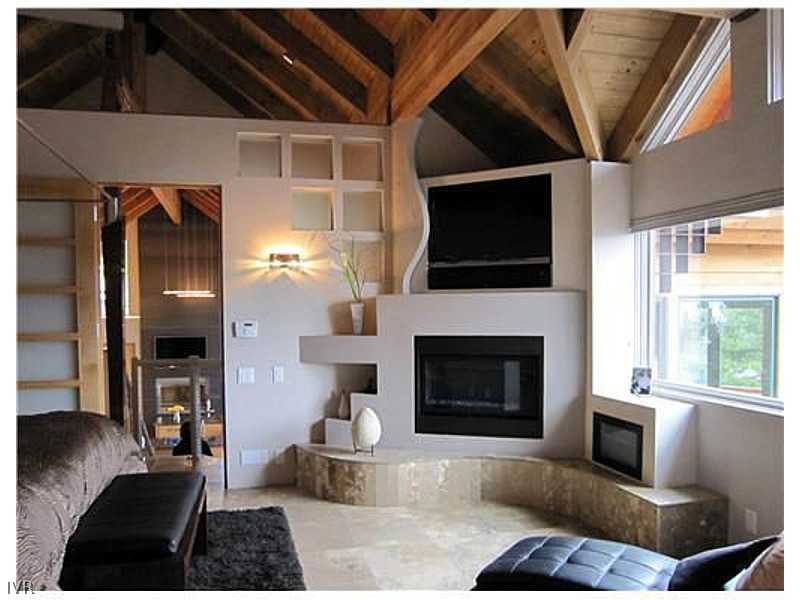 574 Tyner Way Incline Village, NV 89451 - Photo 11 of 34 a living room with furniture a flat screen tv and a fireplace