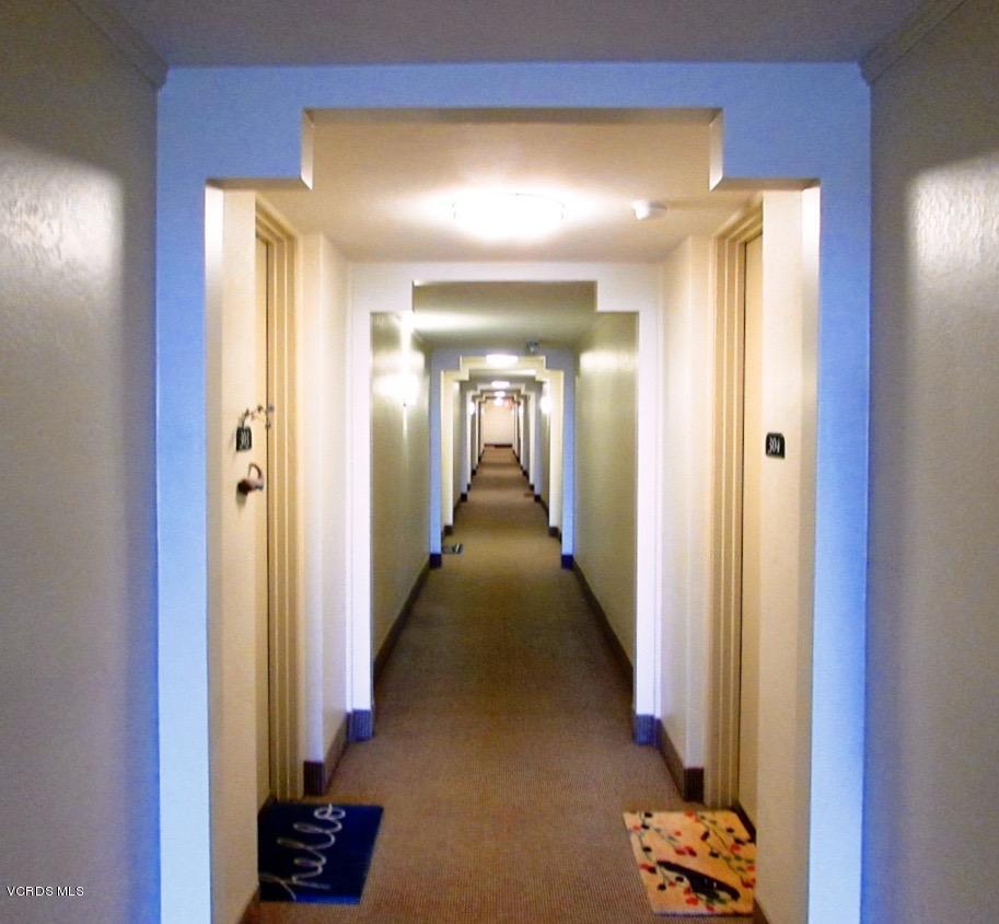 3101 Peninsula Road, Unit 312 Oxnard, CA 93035 - Photo 6 of 14 a view of a hallway with a chair