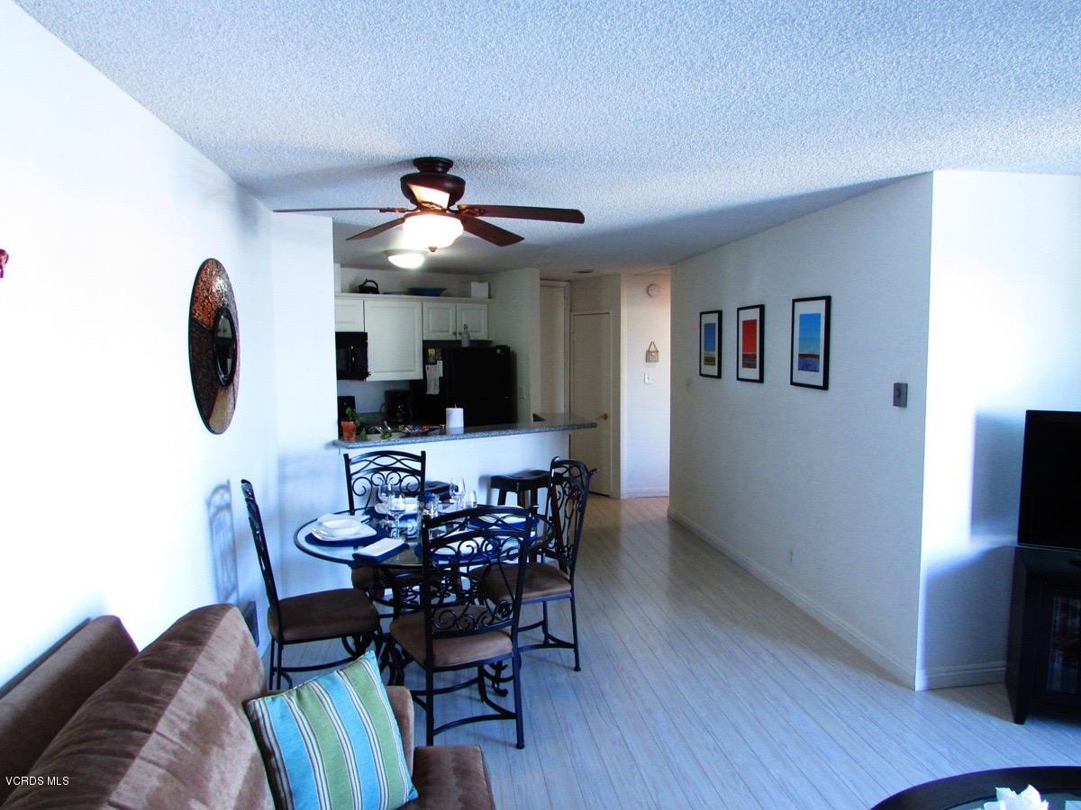 3101 Peninsula Road, Unit 312 Oxnard, CA 93035 - Photo 7 of 14 a view of a dining room with furniture and wooden floor