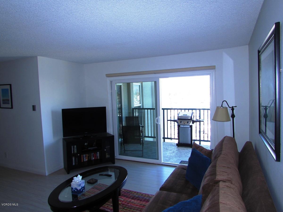 3101 Peninsula Road, Unit 312 Oxnard, CA 93035 - Photo 8 of 14 a living room with furniture and a flat screen tv