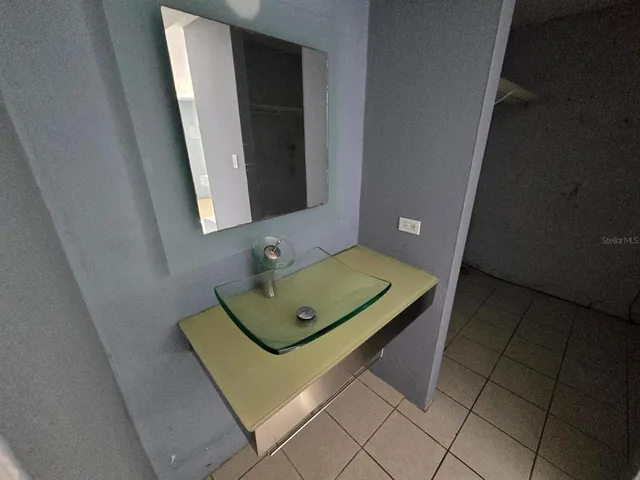 a bathroom with a sink toilet and a mirror