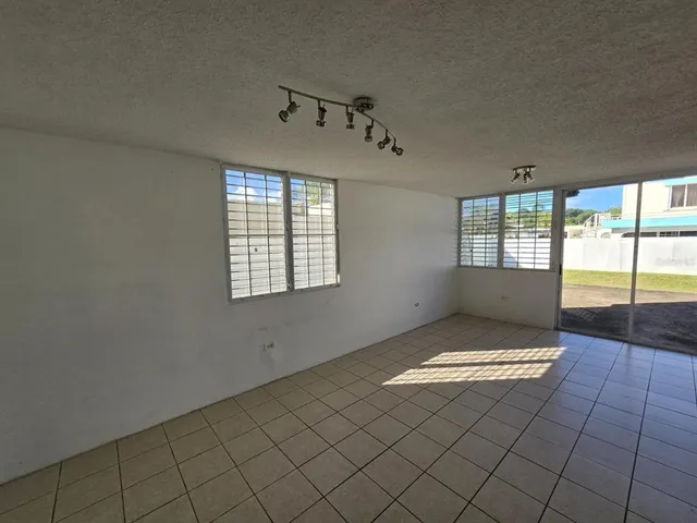 a kitchen with a sink a window and cabinets