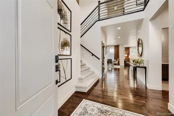 a view of entryway and hall with wooden floor