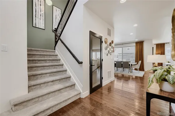 a view of entryway and hall with wooden floor