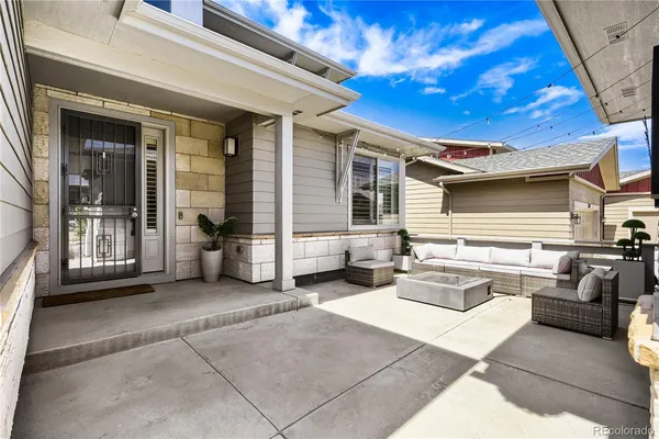 a outdoor space with patio couches and a fireplace