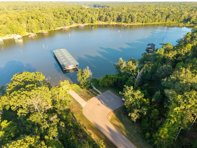 an aerial view of a residential building with swimming pool and outdoor space