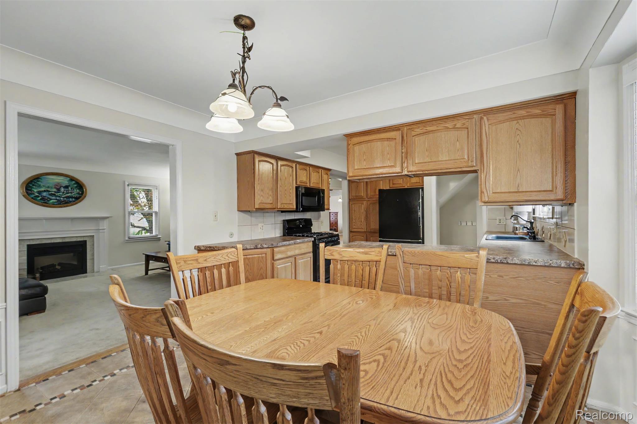 7136 Rosedale Boulevard Allen Park, MI 48101 - Photo 13 of 51 Kitchen with wood-finish cabinetry, solid surface countertops, and an integrated breakfast bar
