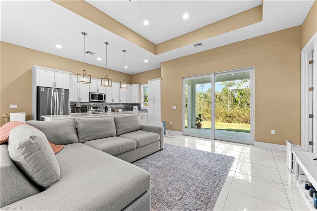 2793 72nd Avenue Northeast Naples, FL 34120 - Photo 11 of 50 a living room with furniture and a large window