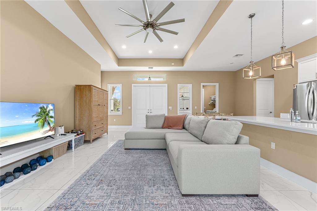 2793 72nd Avenue Northeast Naples, FL 34120 - Photo 12 of 50 a living room with furniture and a chandelier