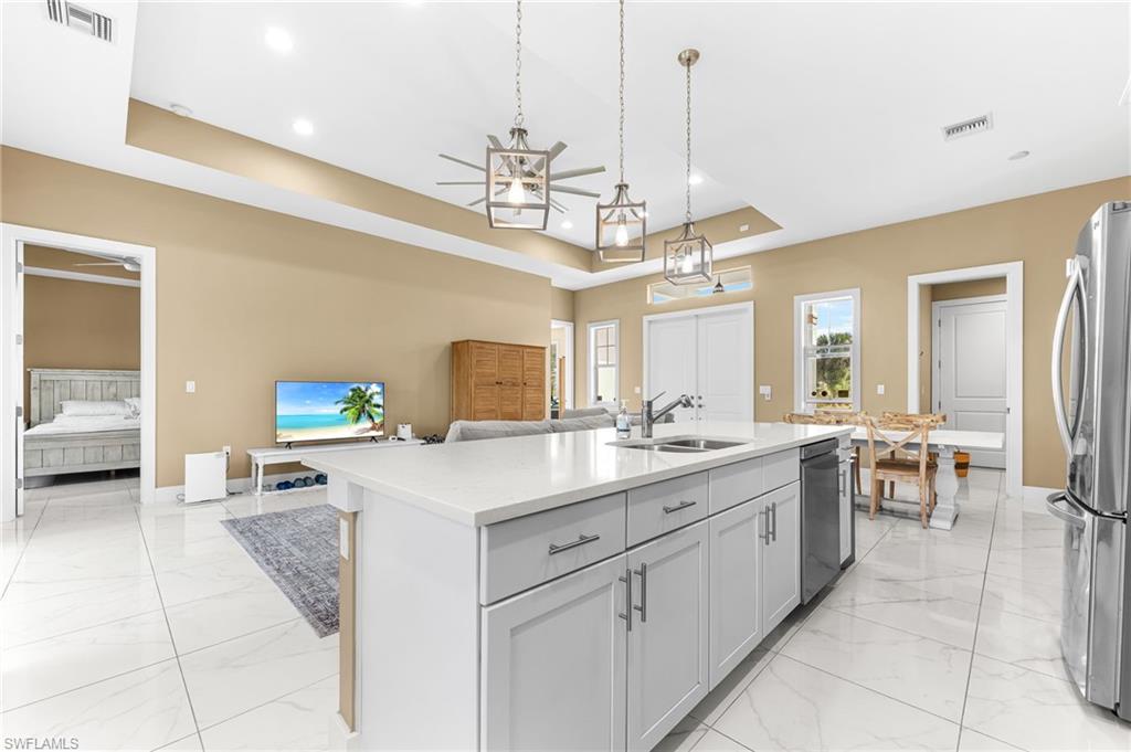 2793 72nd Avenue Northeast Naples, FL 34120 - Photo 15 of 50 a kitchen with a sink counter top space appliances and cabinets