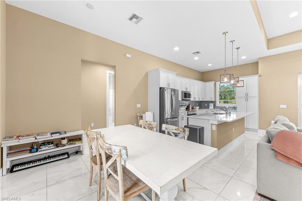 2793 72nd Avenue Northeast Naples, FL 34120 - Photo 22 of 50 a large kitchen with a table and chairs in it
