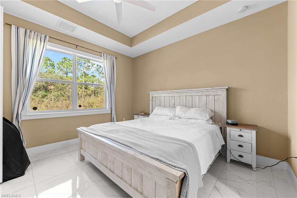 2793 72nd Avenue Northeast Naples, FL 34120 - Photo 25 of 50 a bedroom with a bed and a window