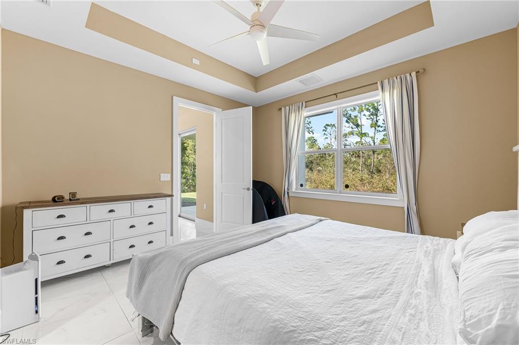 2793 72nd Avenue Northeast Naples, FL 34120 - Photo 27 of 50 a bedroom with a bed and a window