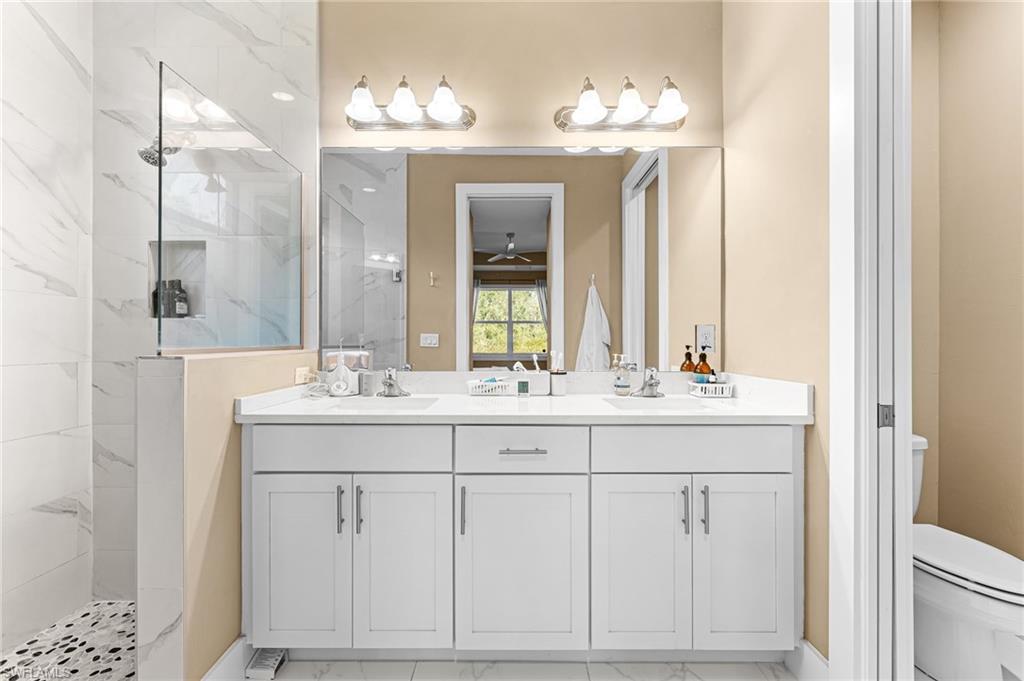 2793 72nd Avenue Northeast Naples, FL 34120 - Photo 28 of 50 a bathroom with a double vanity sink and a mirror