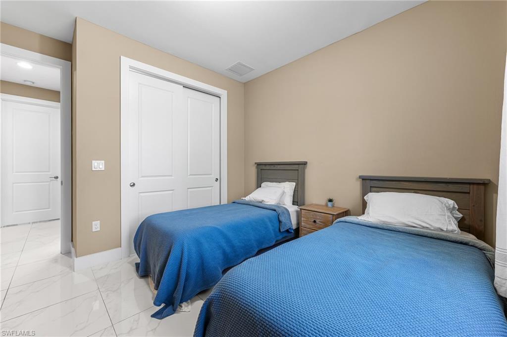2793 72nd Avenue Northeast Naples, FL 34120 - Photo 32 of 50 a bedroom with two beds and painted walls