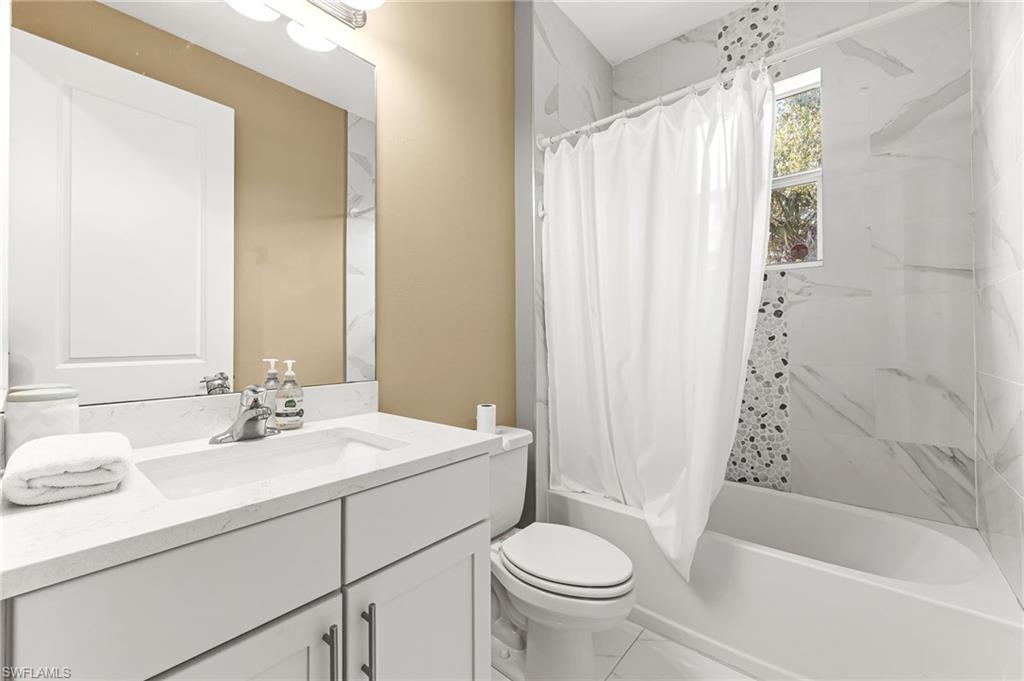 2793 72nd Avenue Northeast Naples, FL 34120 - Photo 33 of 50 a bathroom with a sink toilet and shower