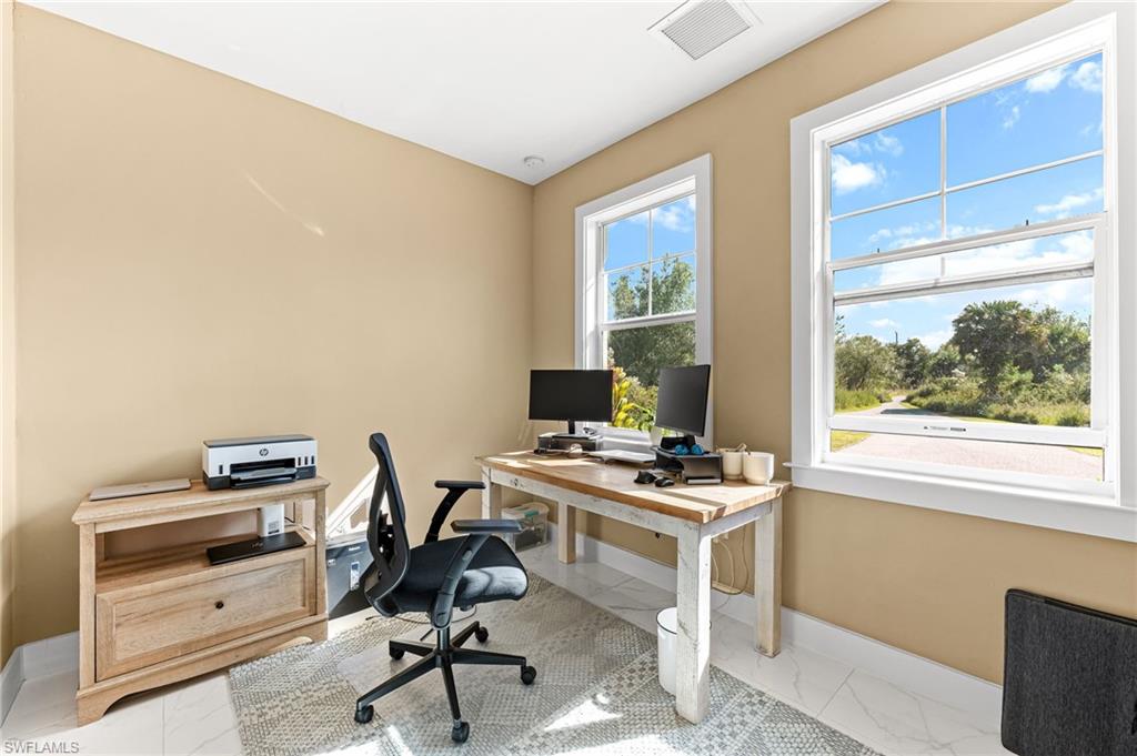 2793 72nd Avenue Northeast Naples, FL 34120 - Photo 34 of 50 a view of a workspace with furniture and a window