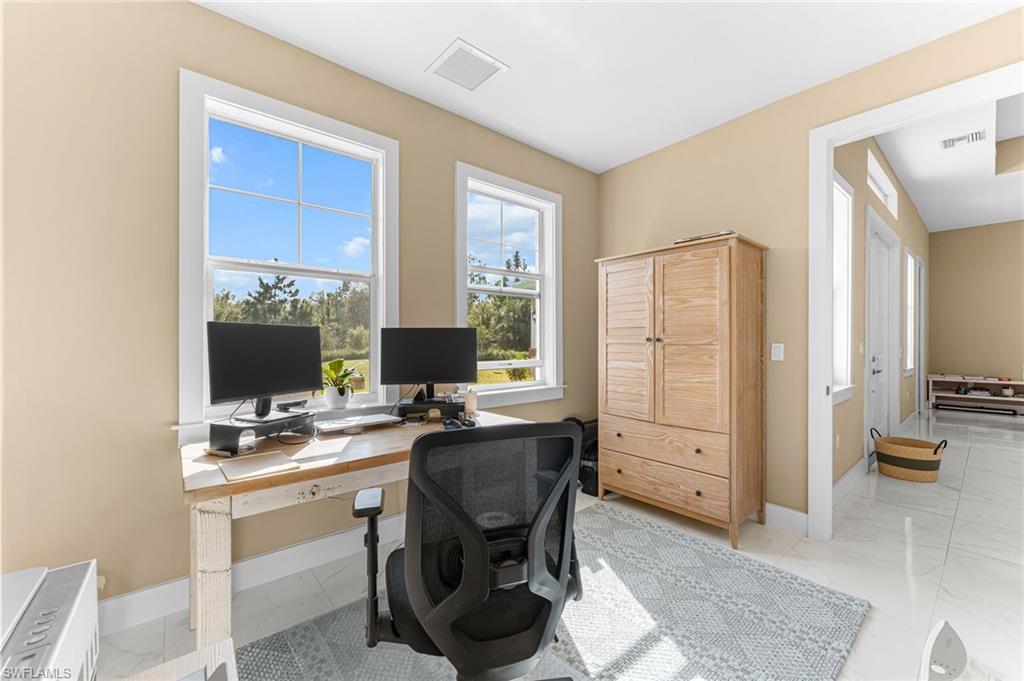 2793 72nd Avenue Northeast Naples, FL 34120 - Photo 35 of 50 a view of a workspace with furniture and a window