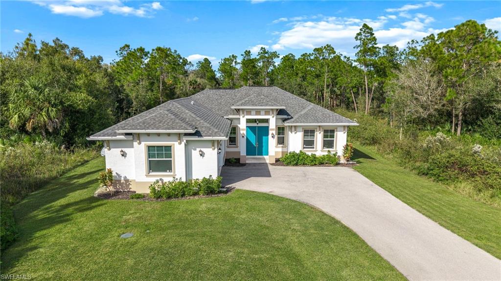 2793 72nd Avenue Northeast Naples, FL 34120 - Photo 41 of 50 a front view of a house with a yard