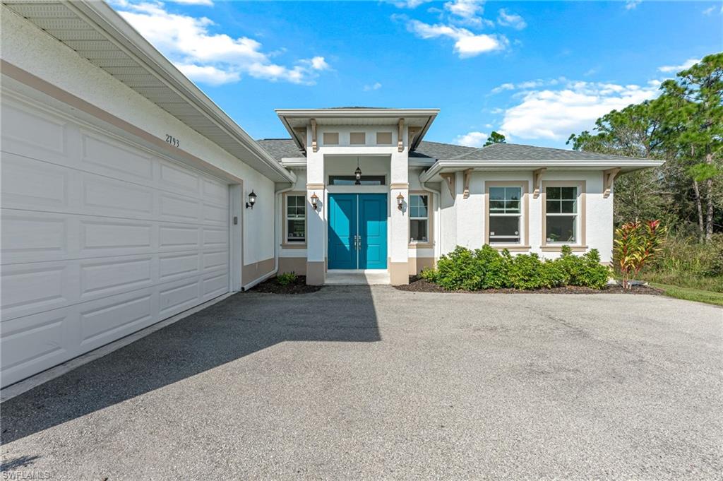 2793 72nd Avenue Northeast Naples, FL 34120 - Photo 5 of 50 a front view of a house with yard