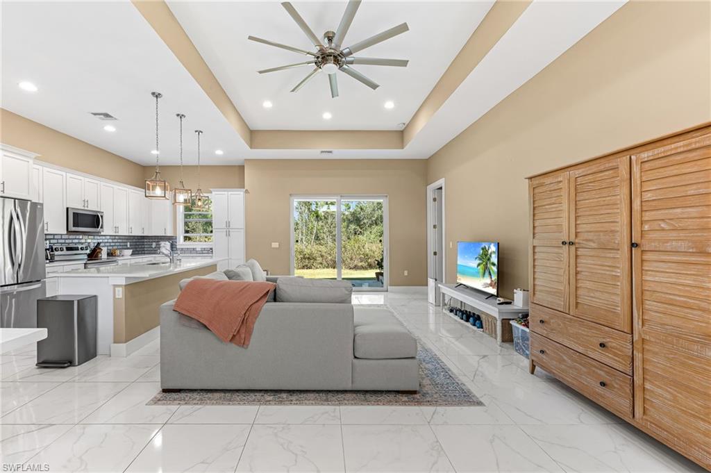 2793 72nd Avenue Northeast Naples, FL 34120 - Photo 6 of 50 a living room with furniture kitchen view and a large window