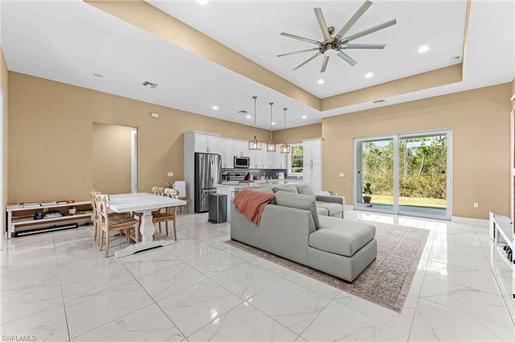 2793 72nd Avenue Northeast Naples, FL 34120 - Photo 7 of 50 a living room with furniture and a large window
