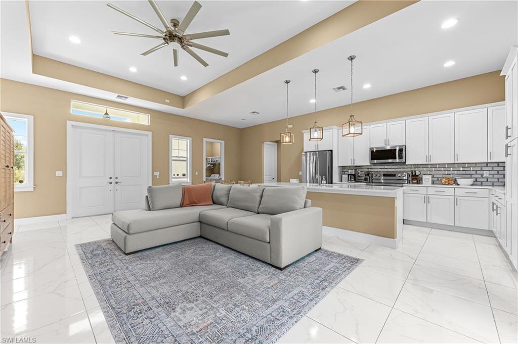 2793 72nd Avenue Northeast Naples, FL 34120 - Photo 9 of 50 a living room with furniture and kitchen view