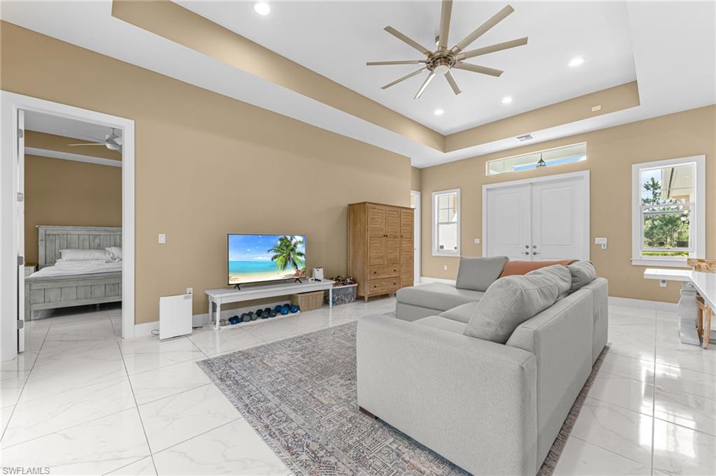 2793 72nd Avenue Northeast Naples, FL 34120 - Photo 10 of 50 a living room with furniture and a flat screen tv