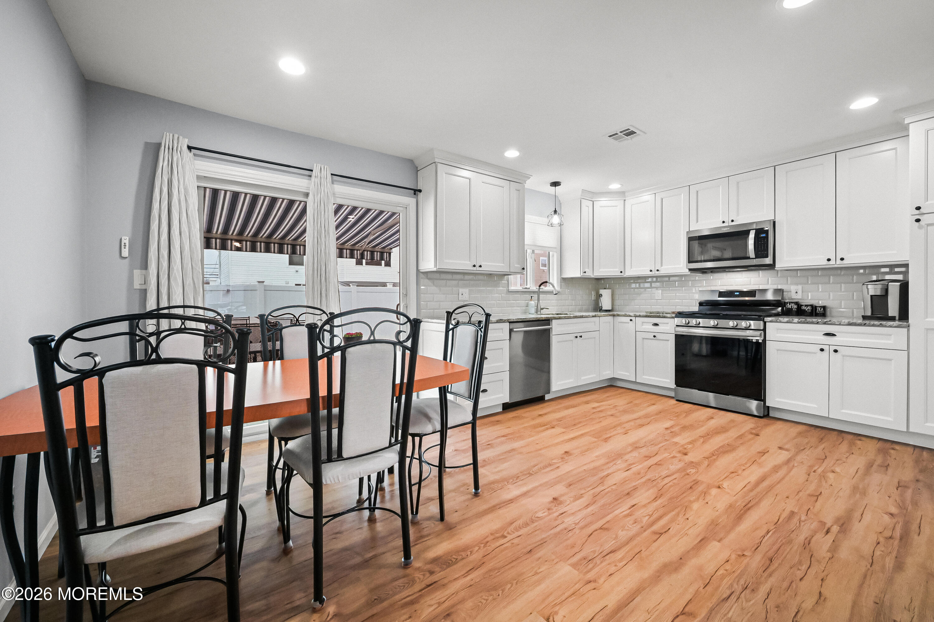 5 Limerick Place Hazlet, NJ 07730 - Photo 13 of 47 a large kitchen with stainless steel appliances granite countertop a stove top oven a sink dishwasher and white cabinets with wooden floor
