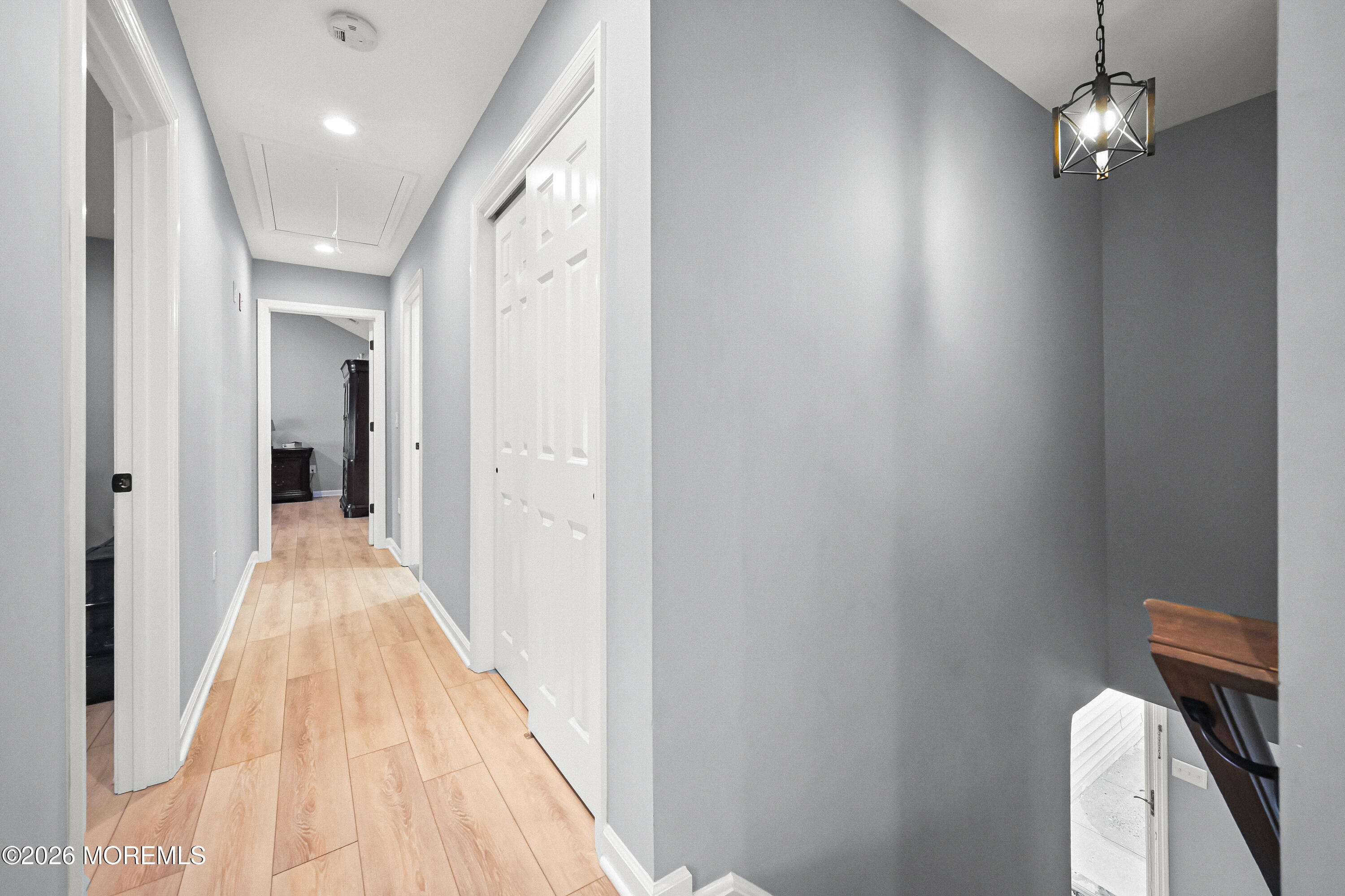 5 Limerick Place Hazlet, NJ 07730 - Photo 21 of 47 a view of a hallway with wooden floor and chandelier