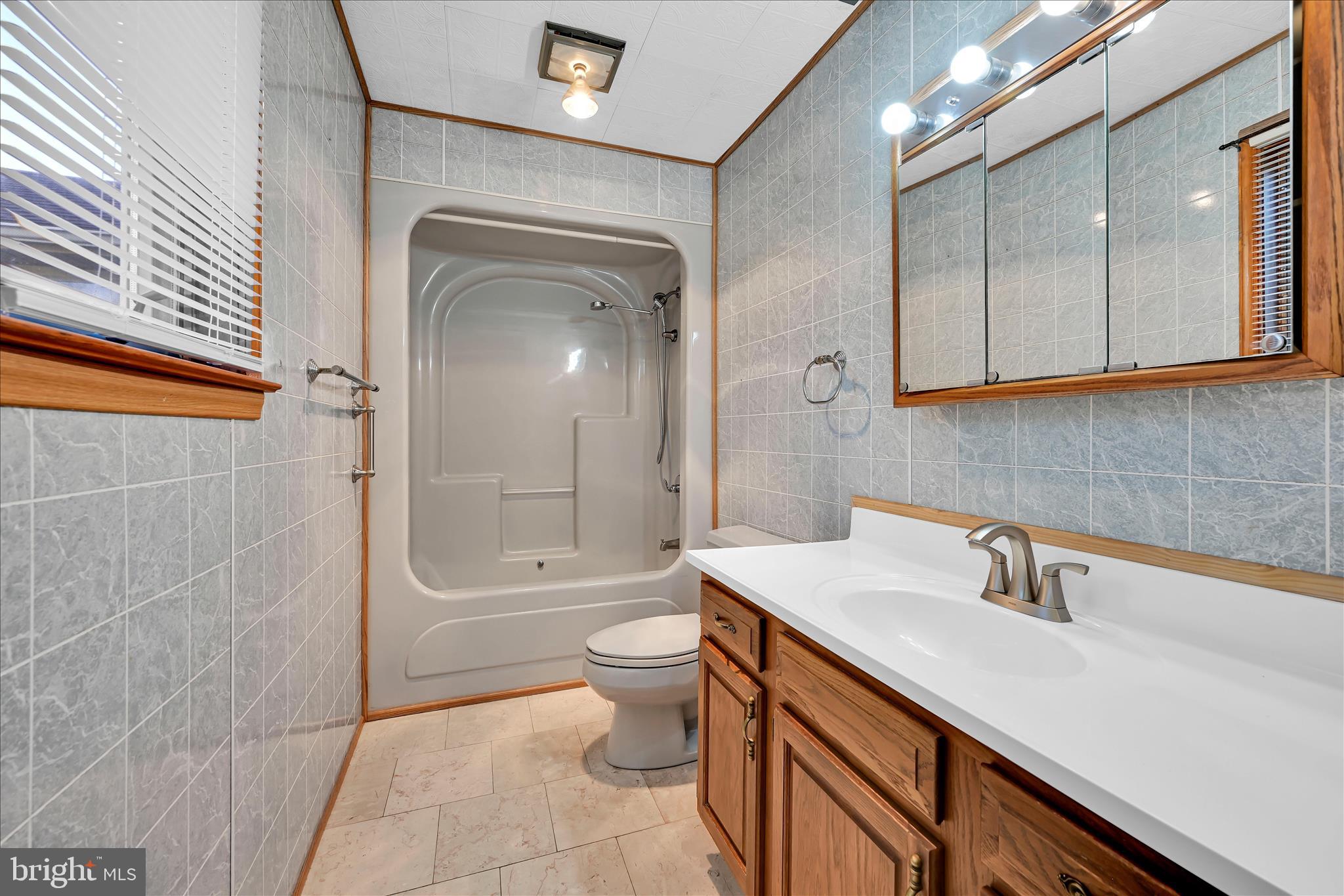 1039 Summer Hill Road Auburn, PA 17922 - Photo 15 of 40 a bathroom with a sink a toilet and shower