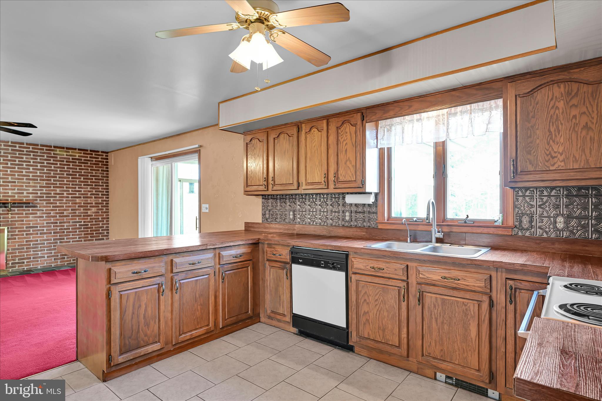 1039 Summer Hill Road Auburn, PA 17922 - Photo 18 of 40 a kitchen with a sink stove and cabinets