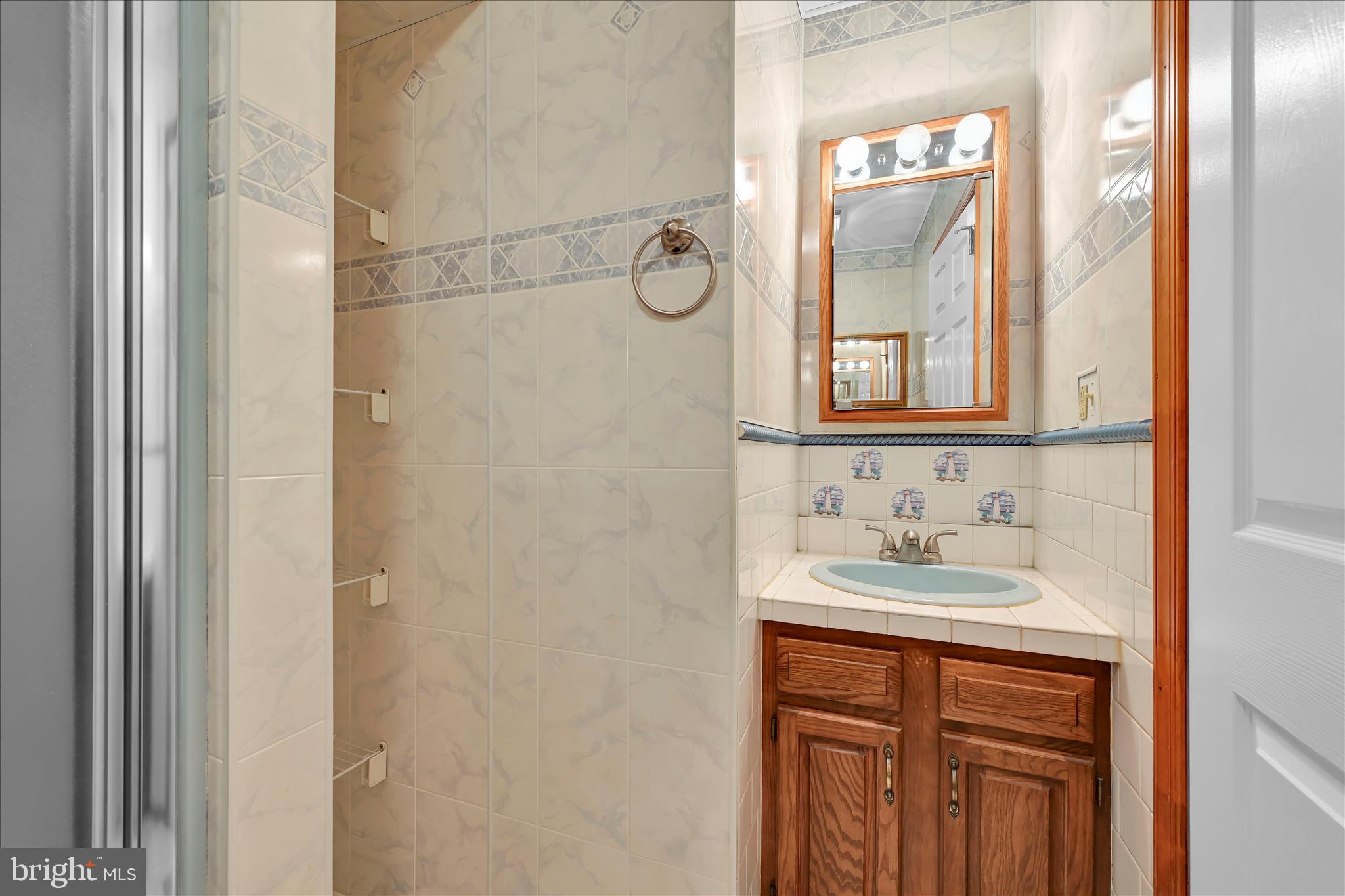 1039 Summer Hill Road Auburn, PA 17922 - Photo 29 of 40 a bathroom with a sink and a mirror